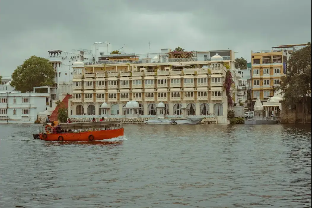 Boat cruising on Lake Pichola during golden hour