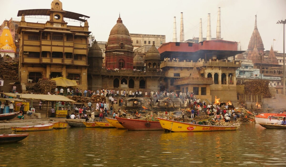 Traditional boats floating on the Ganges River at sunrise in Varanasi during February